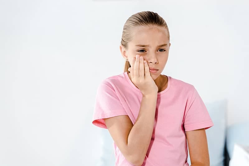Parent helping child with dental emergency